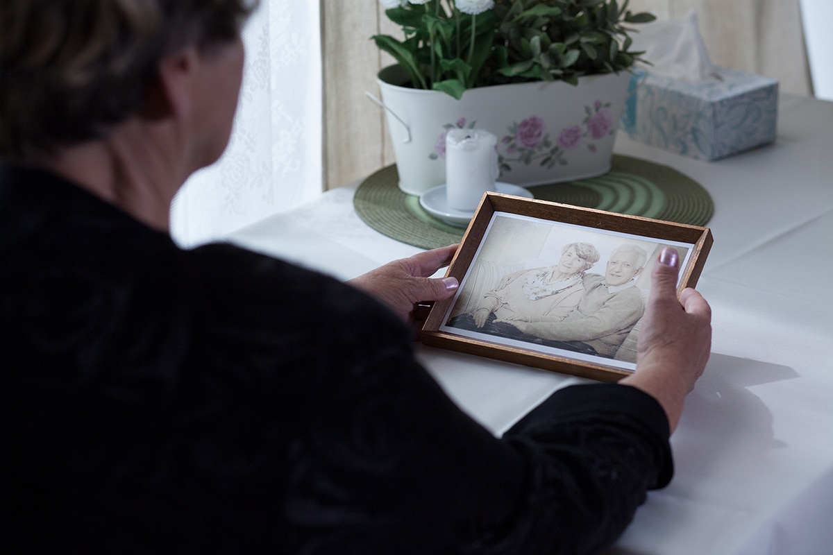 Widow Picture of a lonely widow holding a photo from her past.