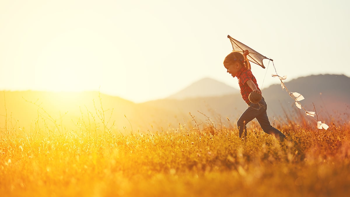 Kid flying a kite.