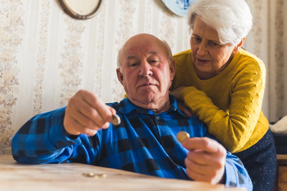Elderly Elderly couple counting change.