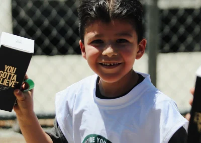 Built 2 Last Sports: Football players holding brochure.
