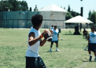Built 2 Last Sports: Football players throwing ball.