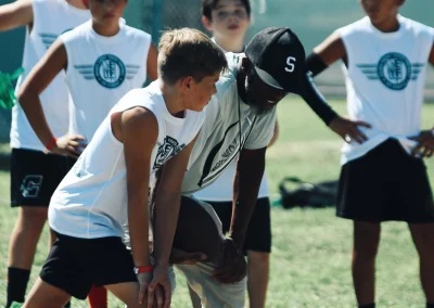 Built 2 Last Sports: Football player talking with coach.