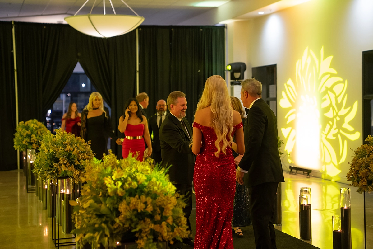 Guests arriving at the Bakersfield Mayor’s Ball entrance decorated with flowers and lights.