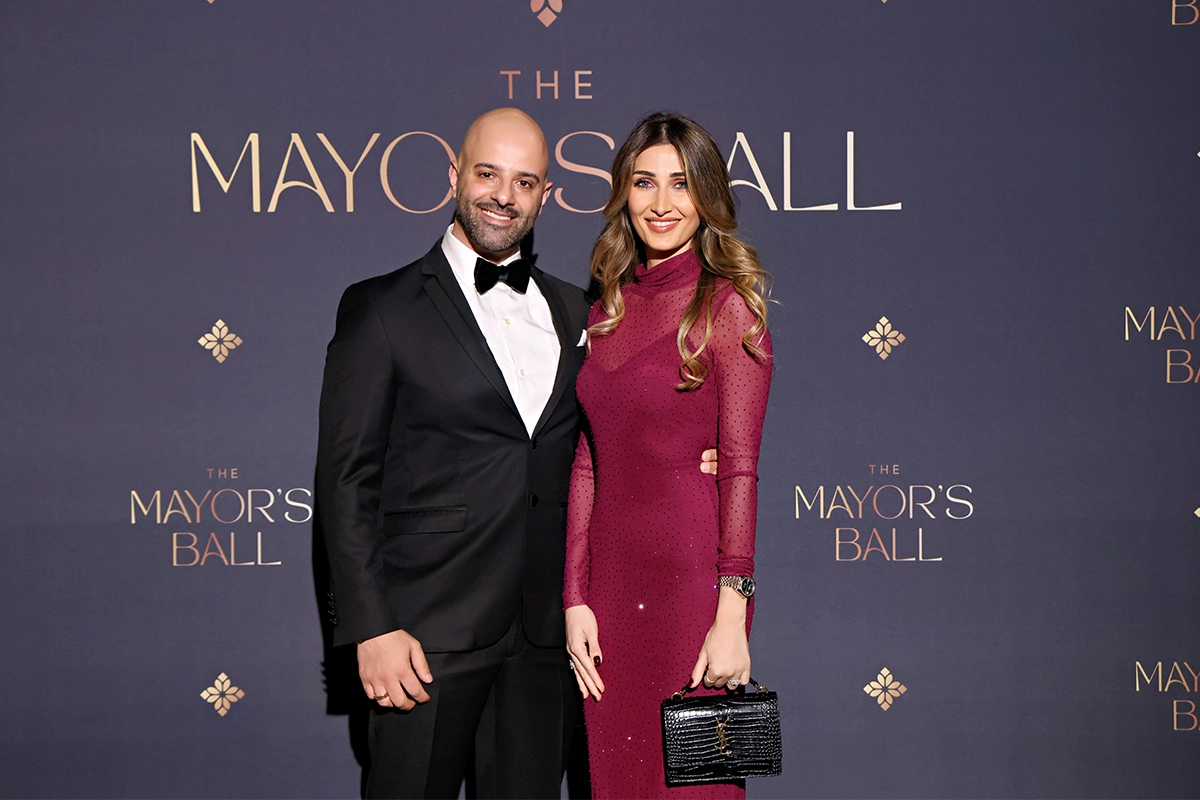 Couple posing on the red carpet backdrop at the Bakersfield Mayor’s Ball.