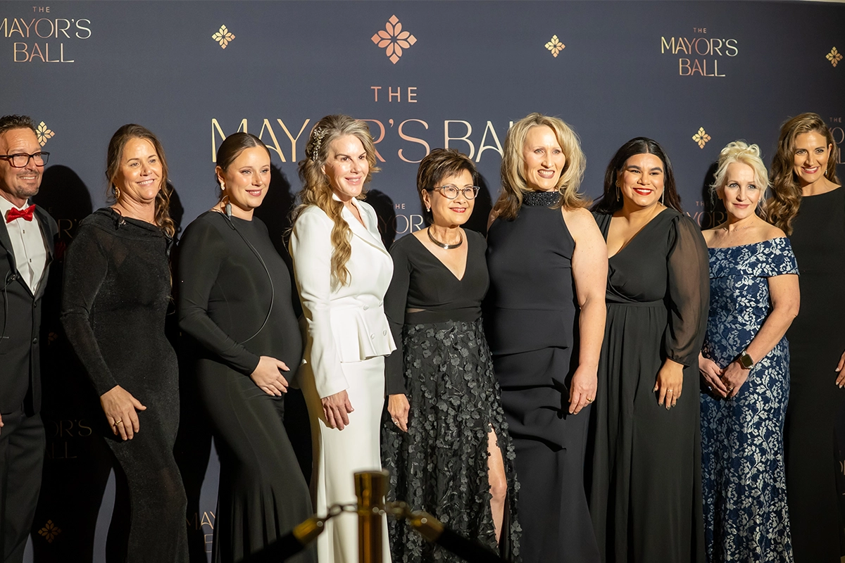 Mayor Karen Goh and guests posing for a group photo at the Bakersfield Mayor’s Ball red carpet backdrop.
