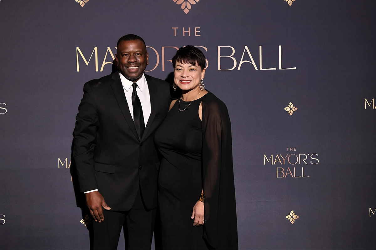 Couple posing on the red carpet backdrop at the Bakersfield Mayor’s Ball.