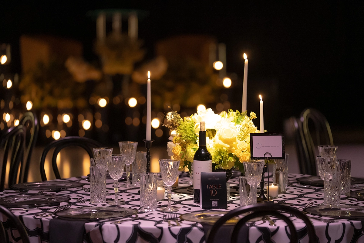 Elegant table setting with candles and floral centerpiece at the Bakersfield Mayor’s Ball.